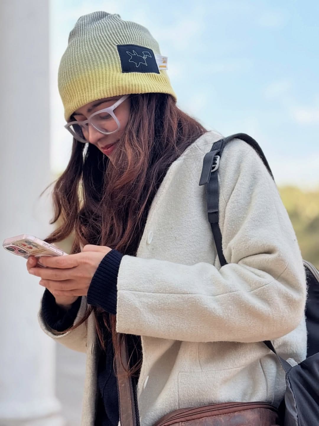 Priya in a beanie and glasses on a winter morning